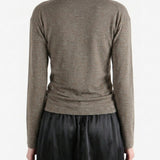 Grey knitwear worn by a person, back view