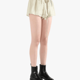 Tan shorts worn by a person, showing the shorts' fit 