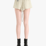 Tan shorts worn by a person, showing the shorts' fit 