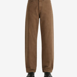 Brown jeans worn by a person, showing the jeans fit