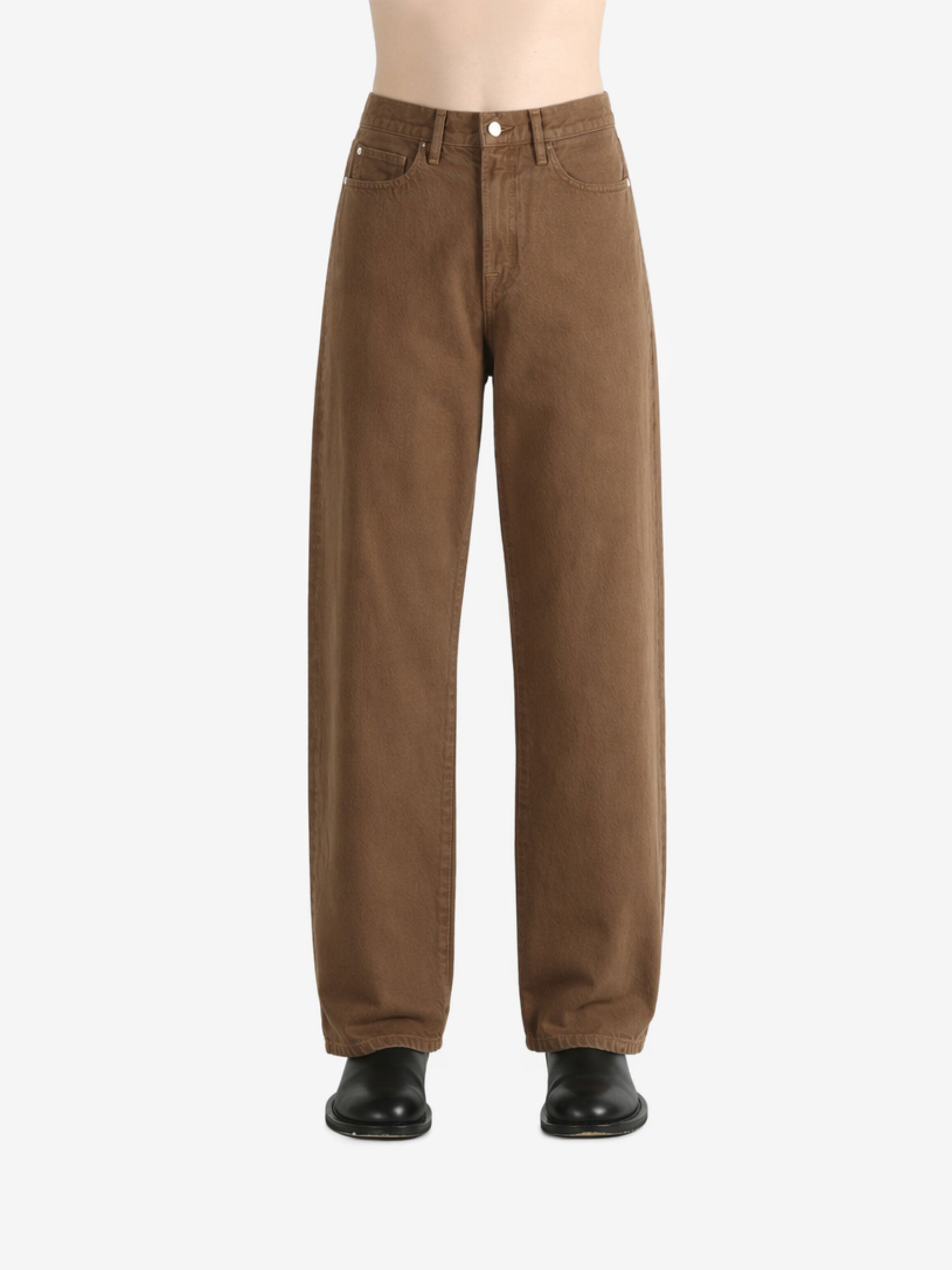 Brown jeans worn by a person, showing the jeans fit