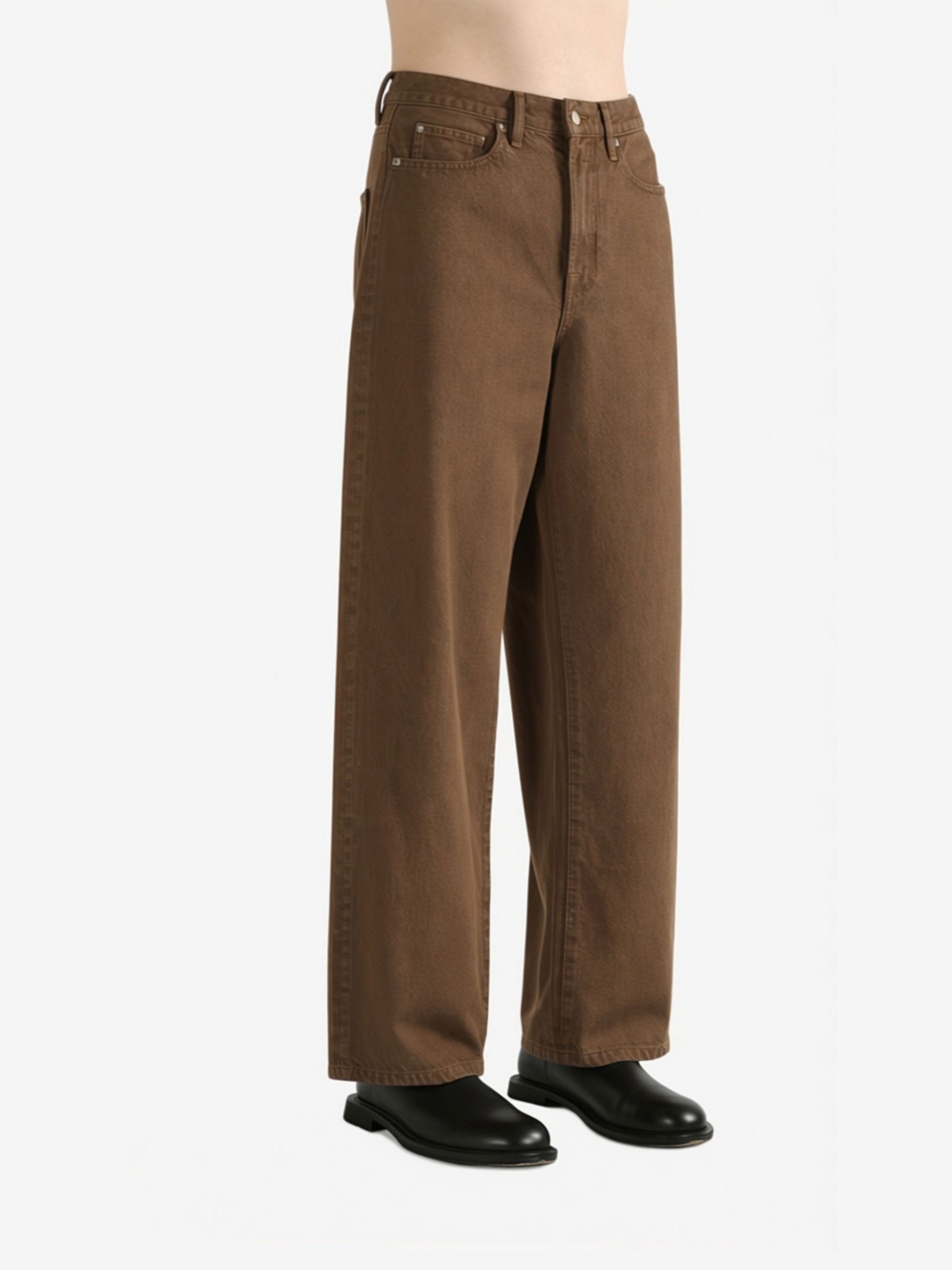 Brown jeans worn by a person, showing the jeans fit