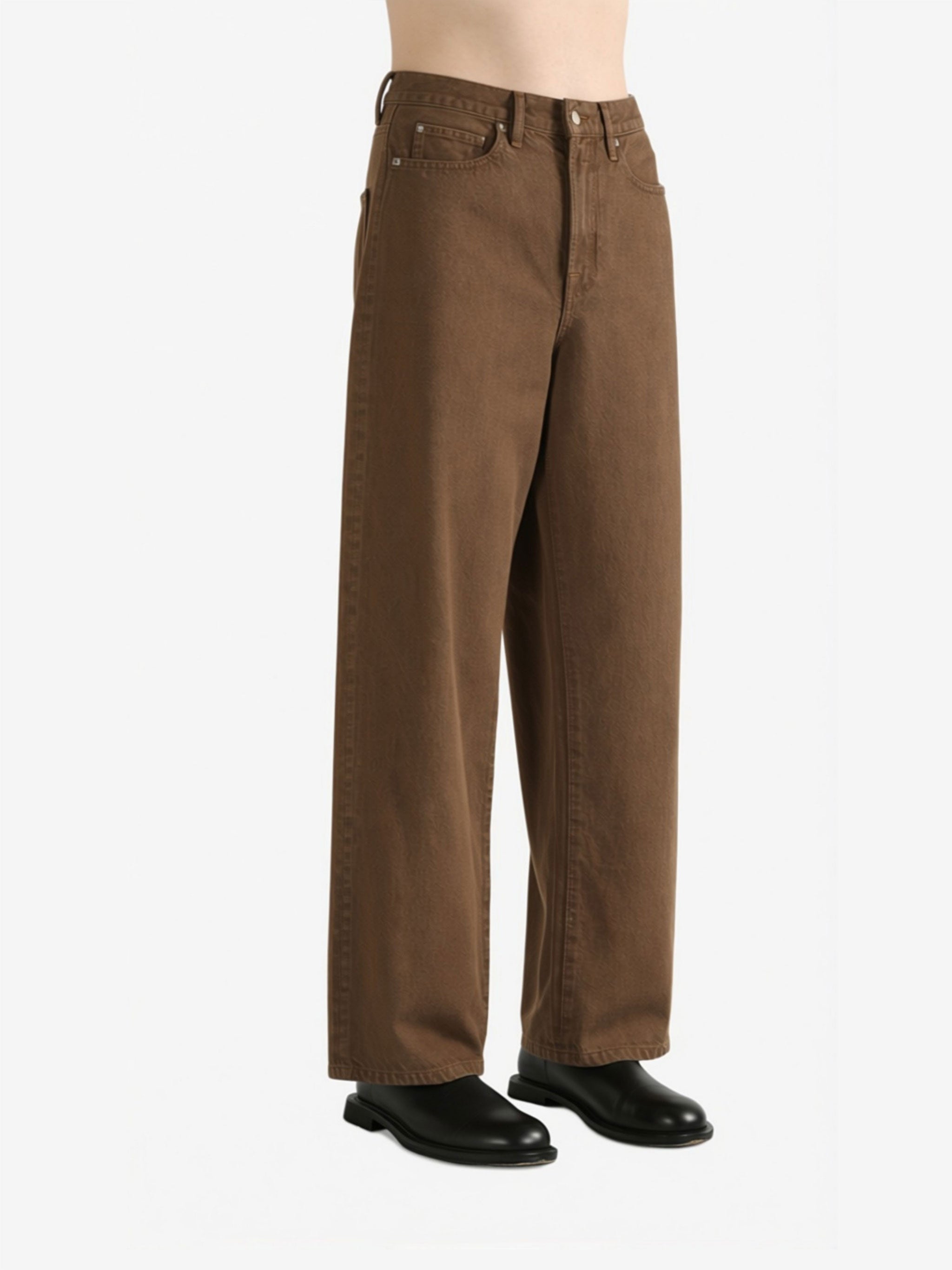 Brown jeans worn by a person, showing the jeans fit