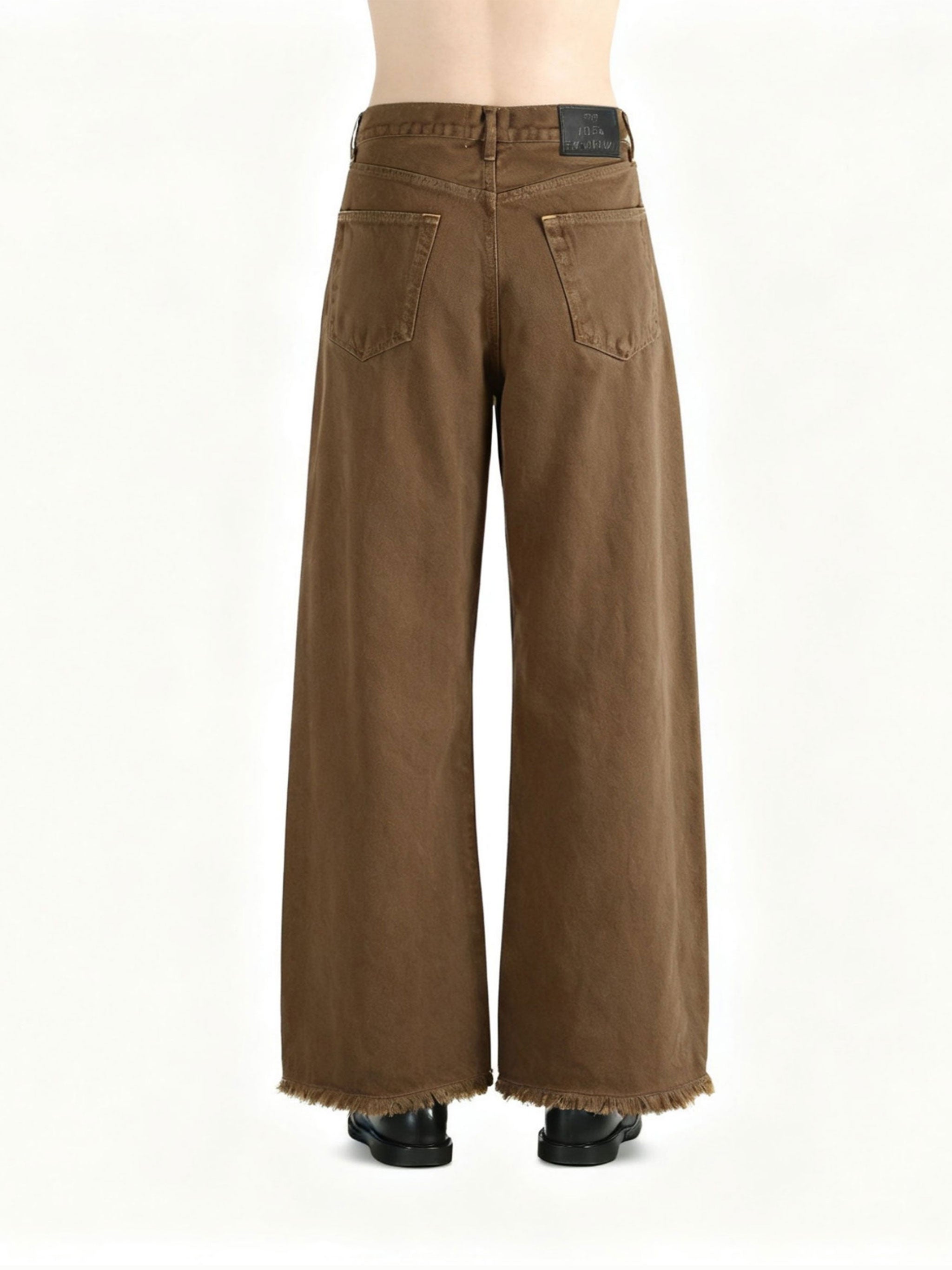 Brown jeans worn by a person, showing the jeans fit