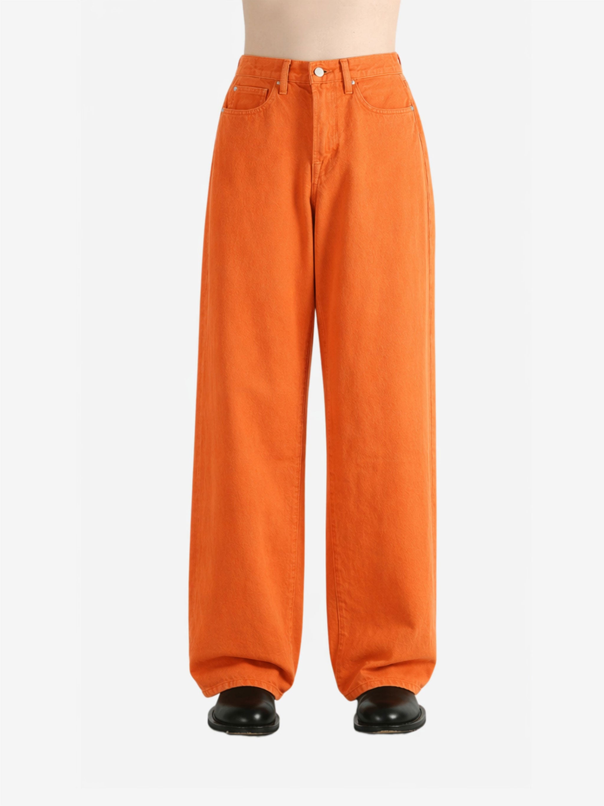 Orange jeans worn by a person,showing the jeans fit