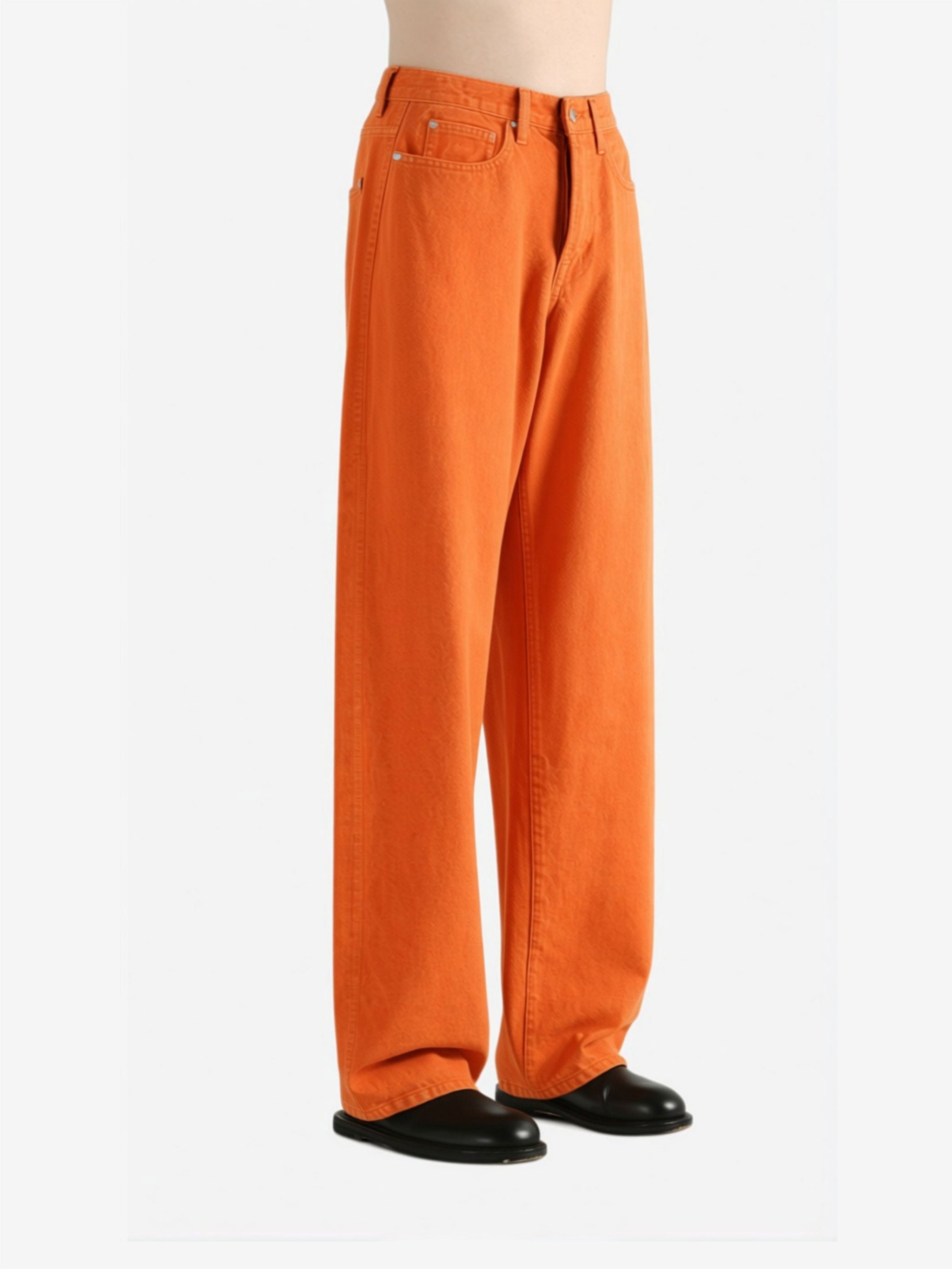 Orange jeans worn by a person,showing the jeans fit