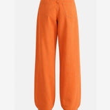 Orange jeans worn by a person,showing the jeans fit