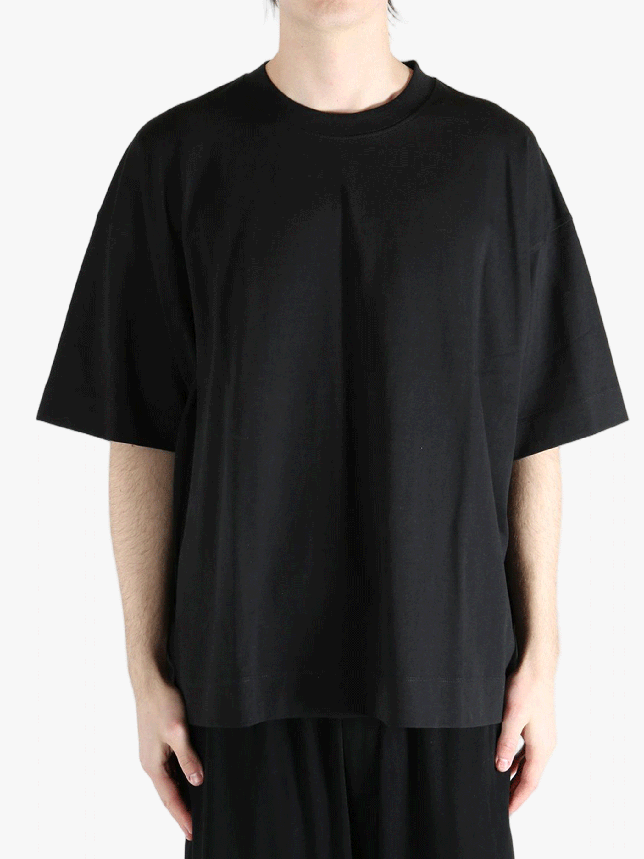 Black t-shirt worn by a person, showing the shirt's fit