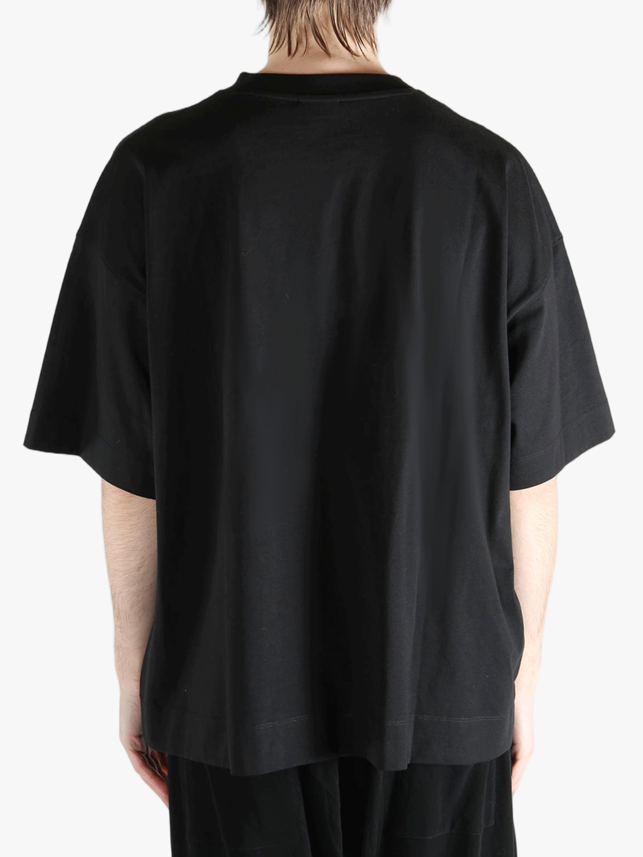 Black t-shirt worn by a person, showing the shirt's fit