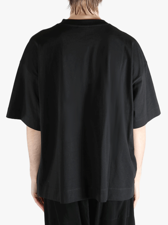Black t-shirt worn by a person, showing the shirt's fit