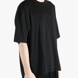 Black t-shirt worn by a person, showing the shirt's fit