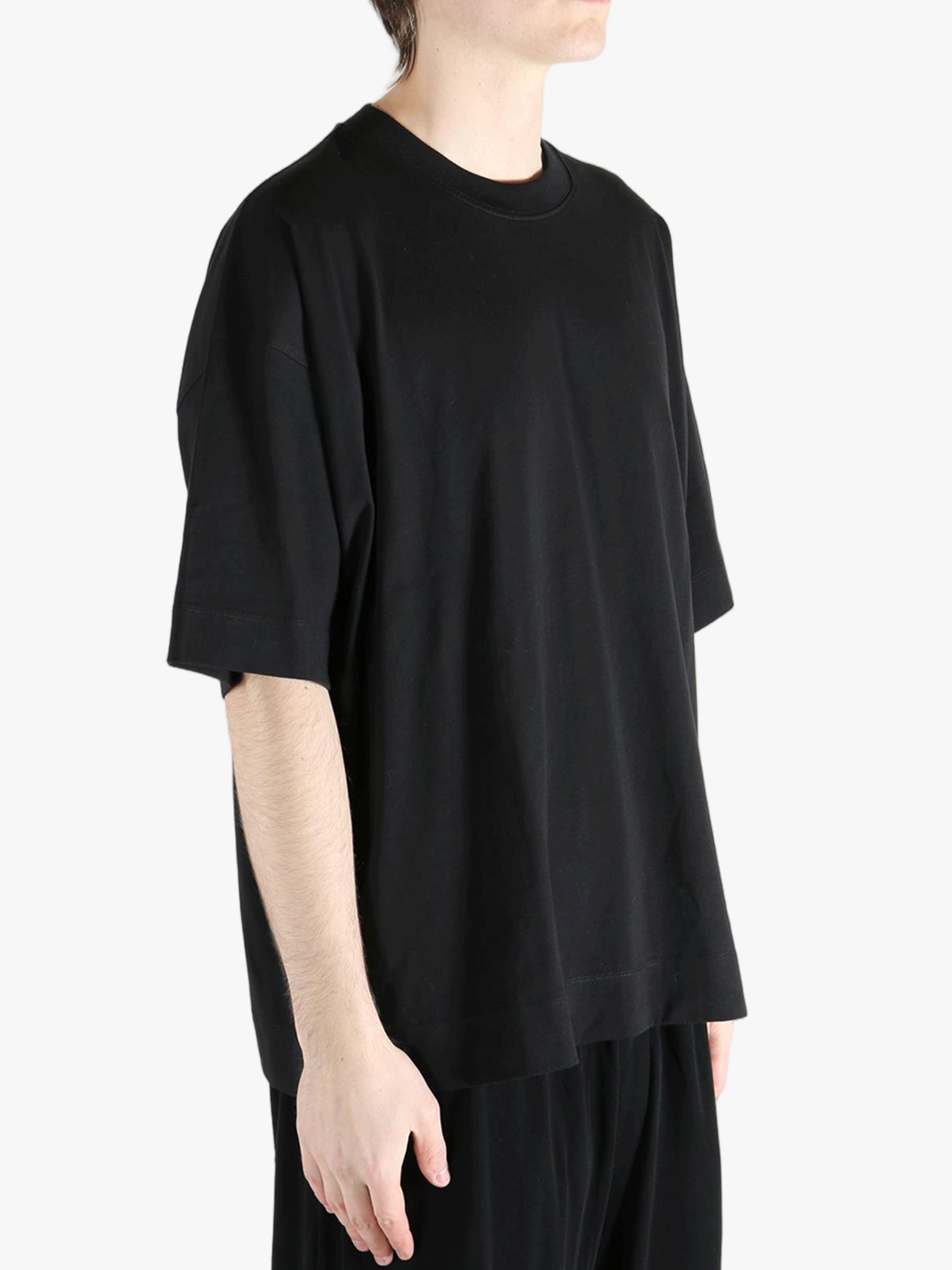 Black t-shirt worn by a person, showing the shirt's fit