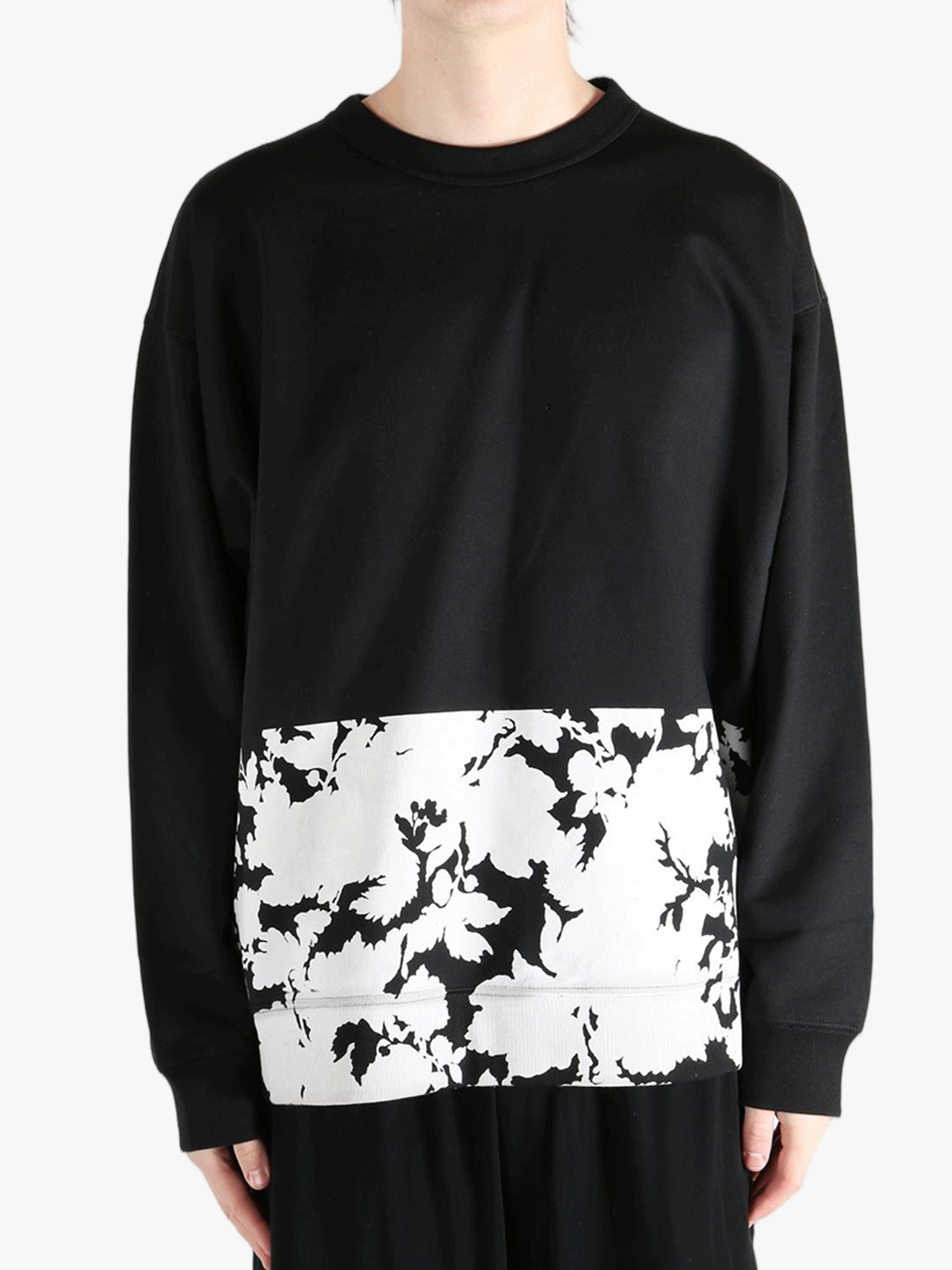 Black sweatshirt worn by a person, showing the sweatshirt's fit