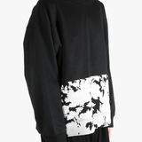 Black sweatshirt worn by a person, showing the sweatshirt's fit