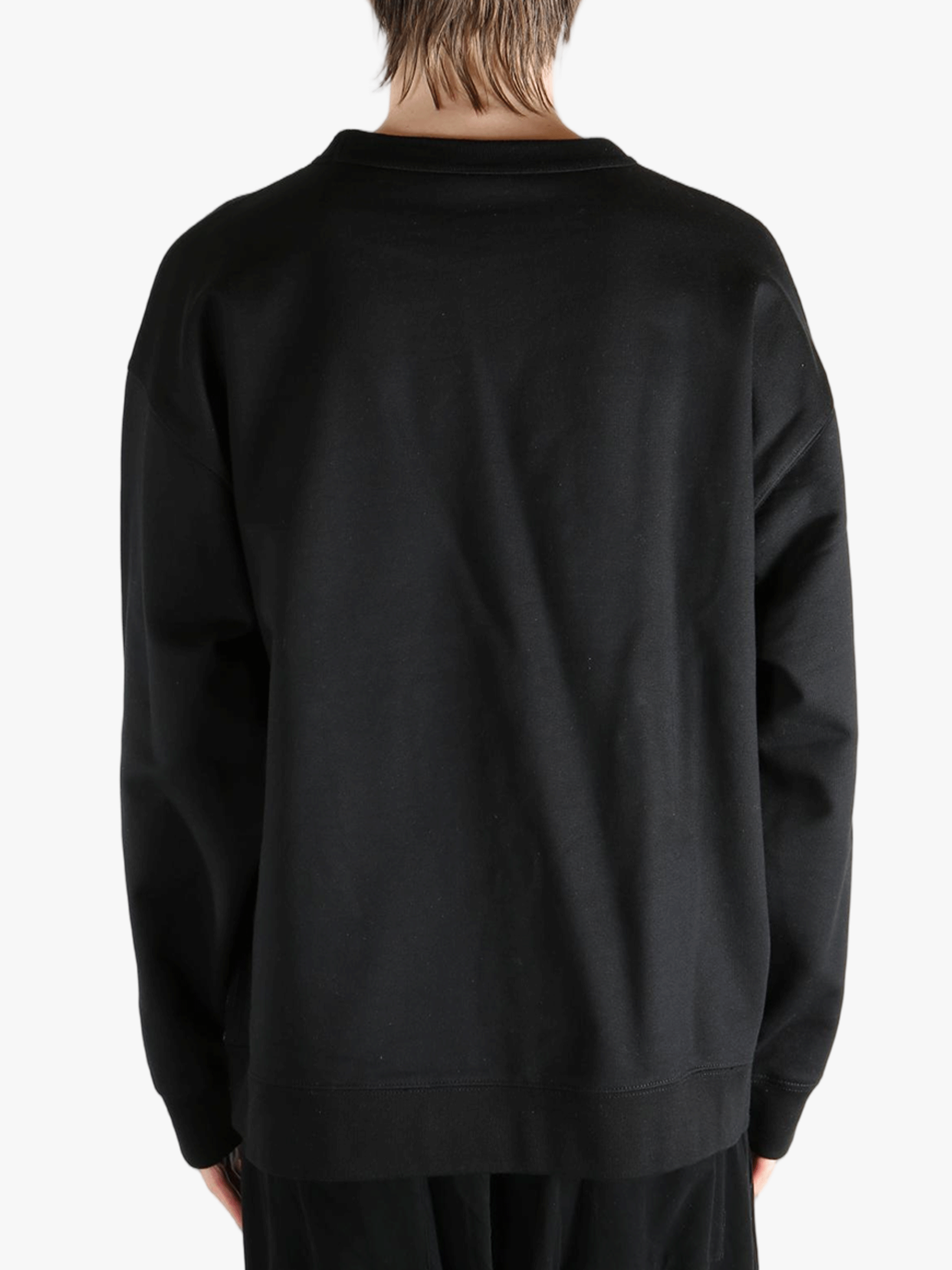 Black sweatshirt worn by a person, showing the sweatshirt's fit