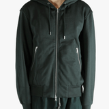Green hoodie worn by a person, showing the hoodie fit