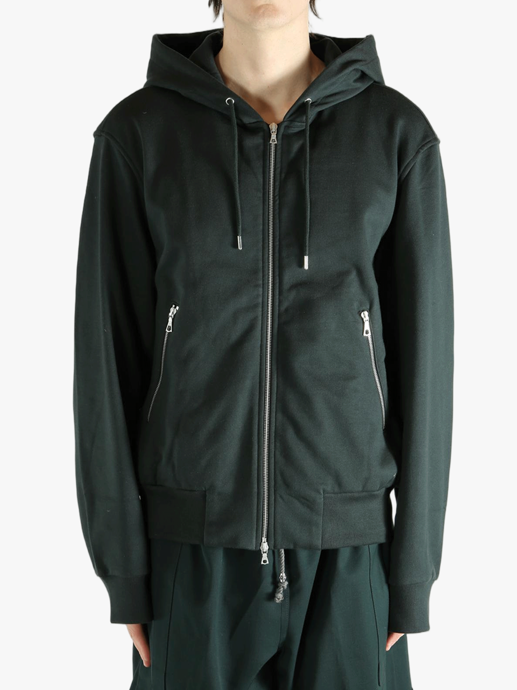 Green hoodie worn by a person, showing the hoodie fit