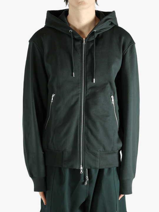 Green hoodie worn by a person, showing the hoodie fit