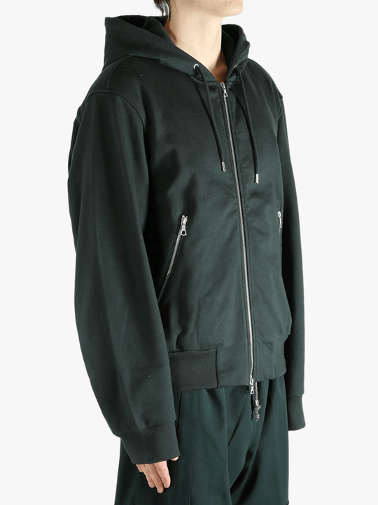 Green hoodie worn by a person, showing the hoodie fit