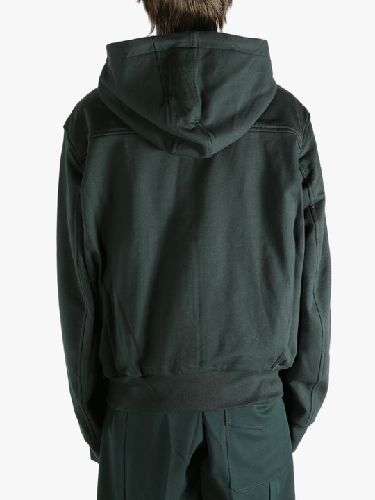 Green hoodie worn by a person, showing the hoodie fit