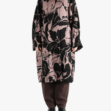 Black coat worn by a person, showing the coat fit