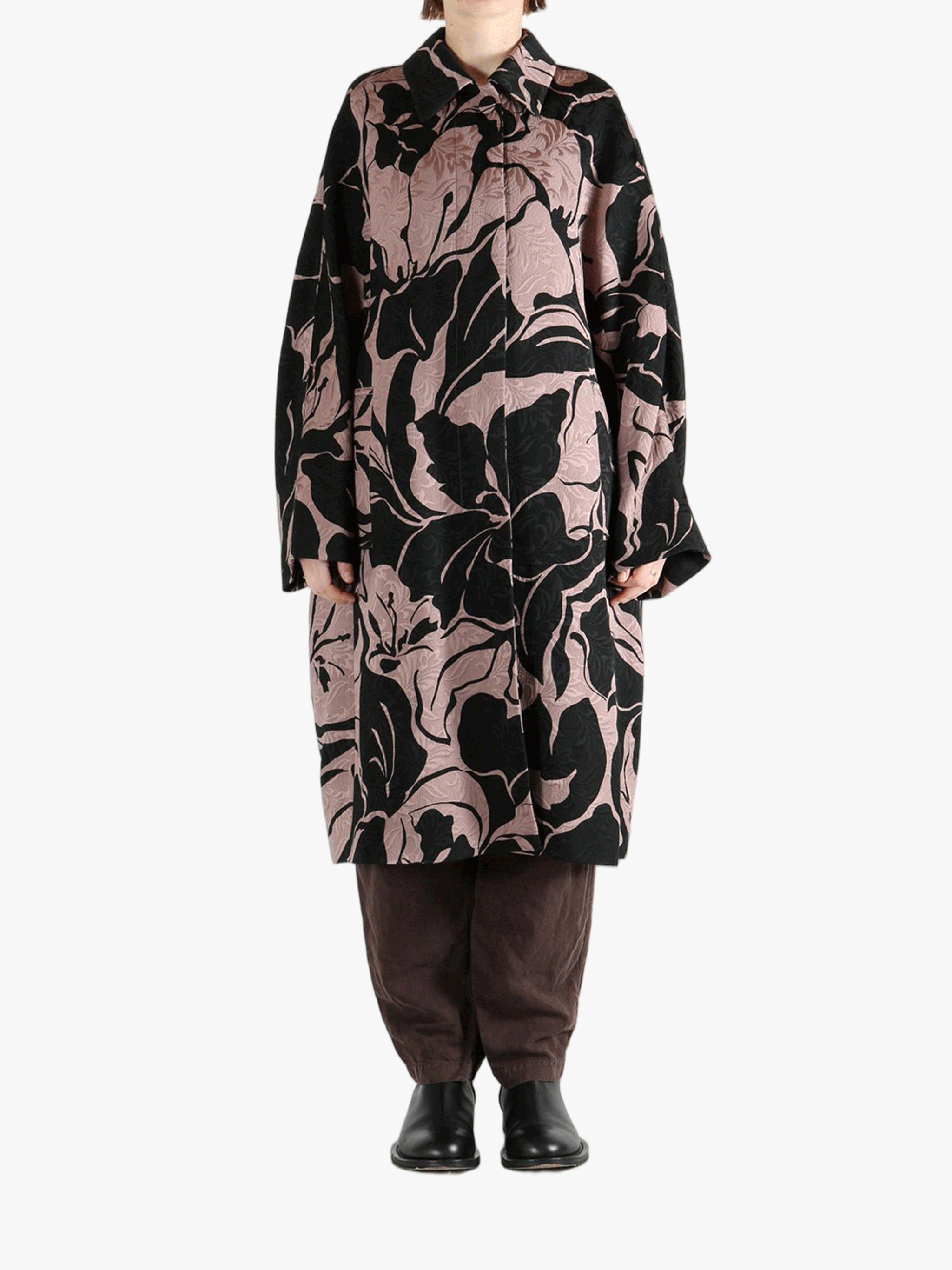 Black coat worn by a person, showing the coat fit