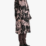 Black coat worn by a person, showing the coat fit