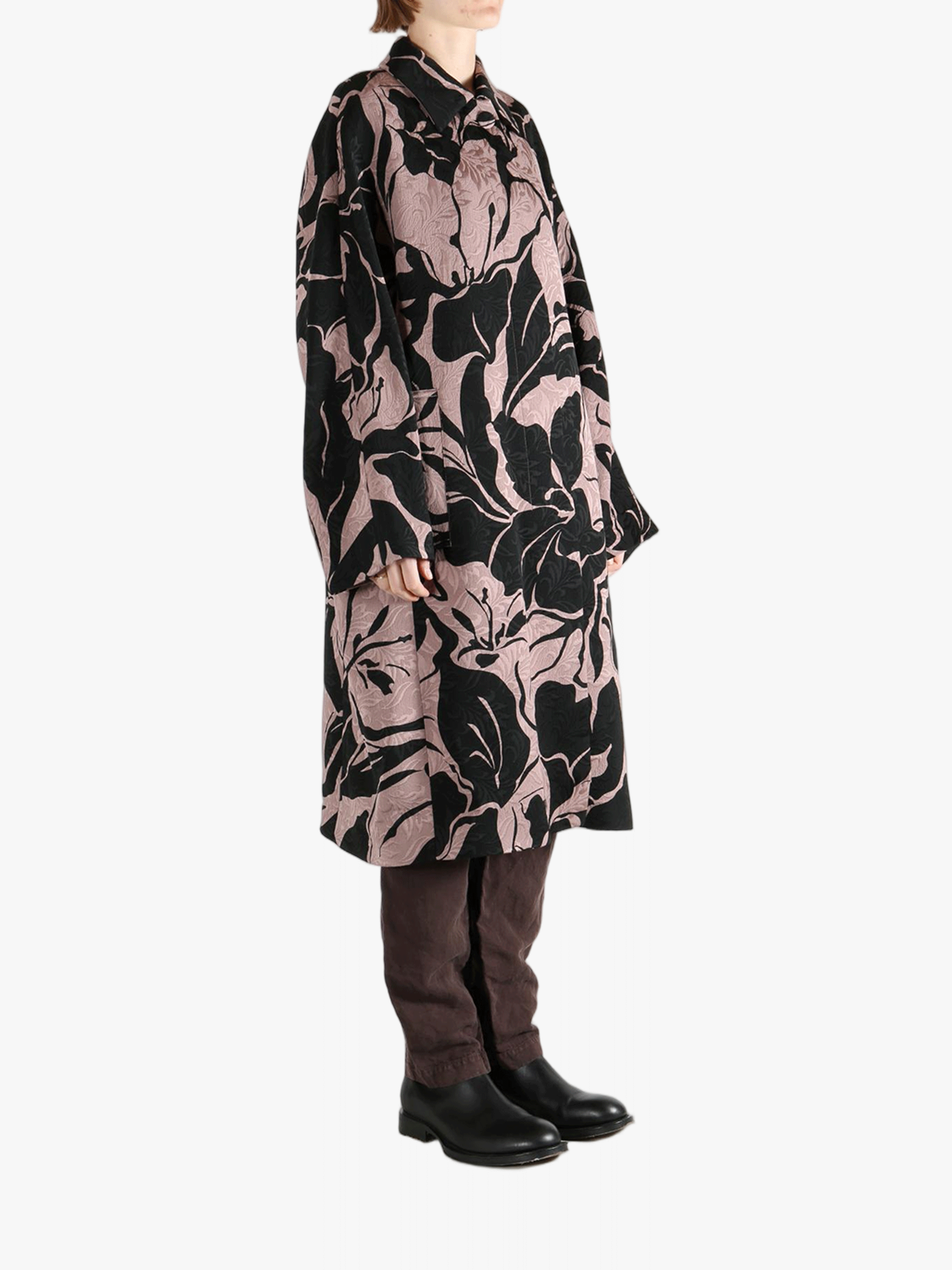 Black coat worn by a person, showing the coat fit