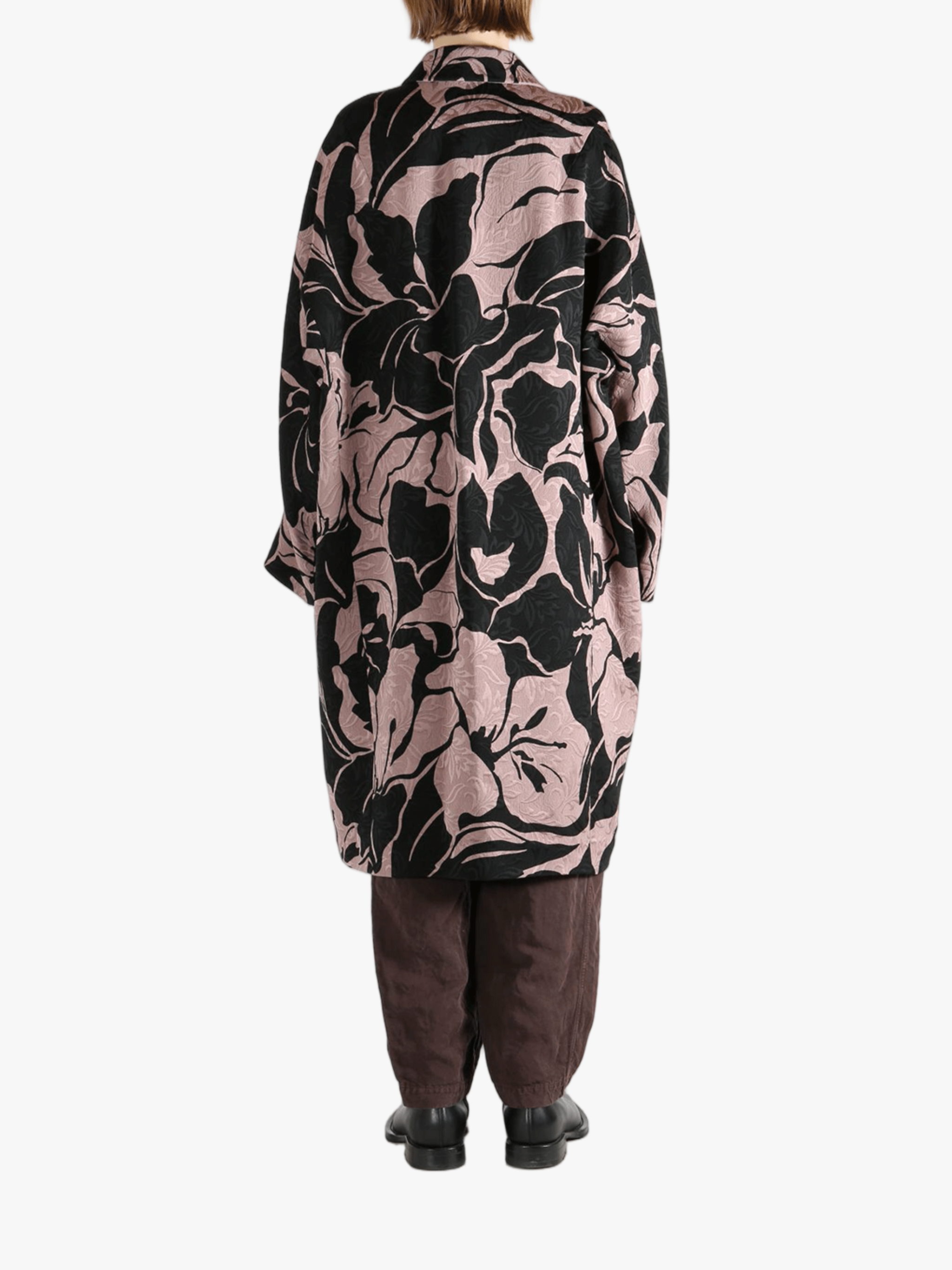 Black coat worn by a person, showing the coat fit