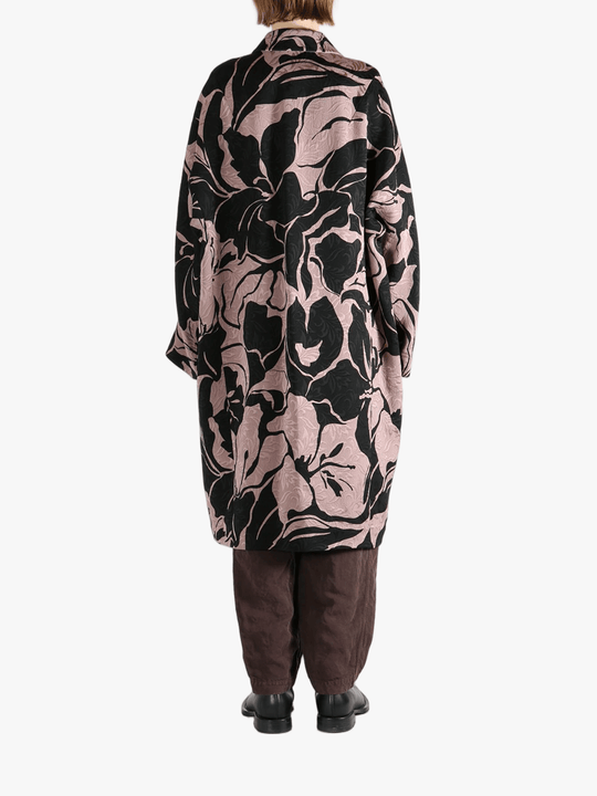 Black coat worn by a person, showing the coat fit