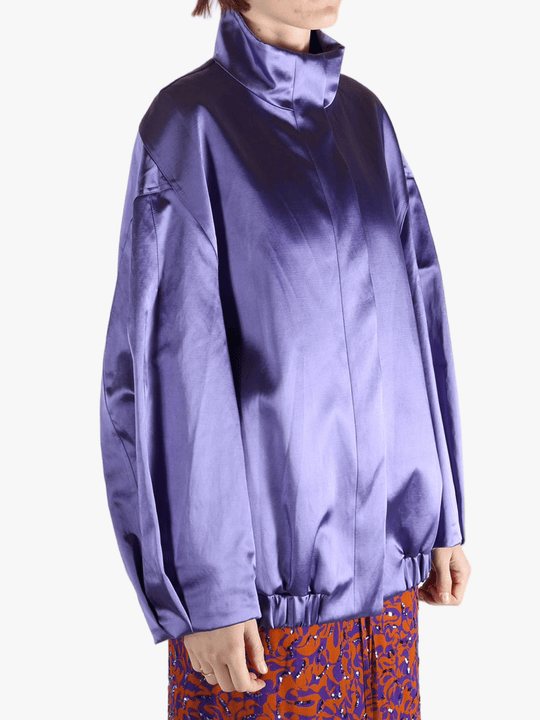 Purple jacket worn by a person, showing the jacket fit