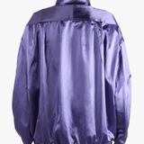 Purple jacket worn by a person, showing the jacket fit