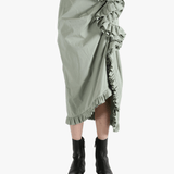 Green dress worn by a person, showing the dress's fit