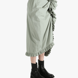 Green dress worn by a person, showing the dress's fit