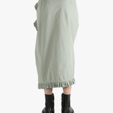 Green dress worn by a person, showing the dress's fit