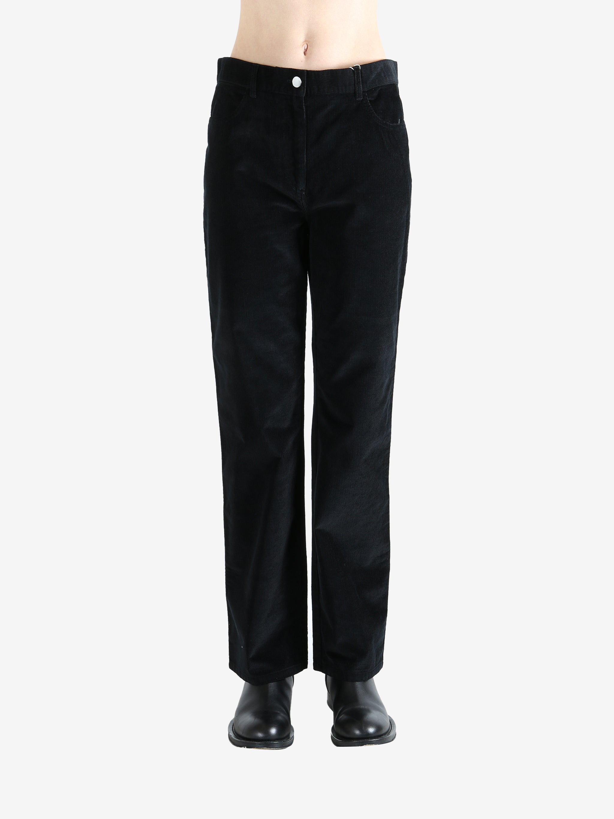 Black pants worn by a person, showing the pants fit