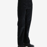 Black pants worn by a person, showing the pants fit