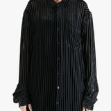 Black shirt worn by a person, showing the shirt's fit