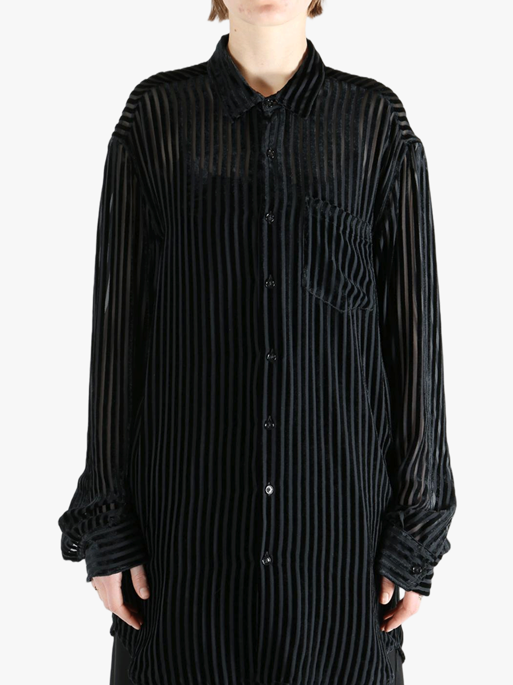 Black shirt worn by a person, showing the shirt's fit
