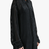 Black shirt worn by a person, showing the shirt's fit