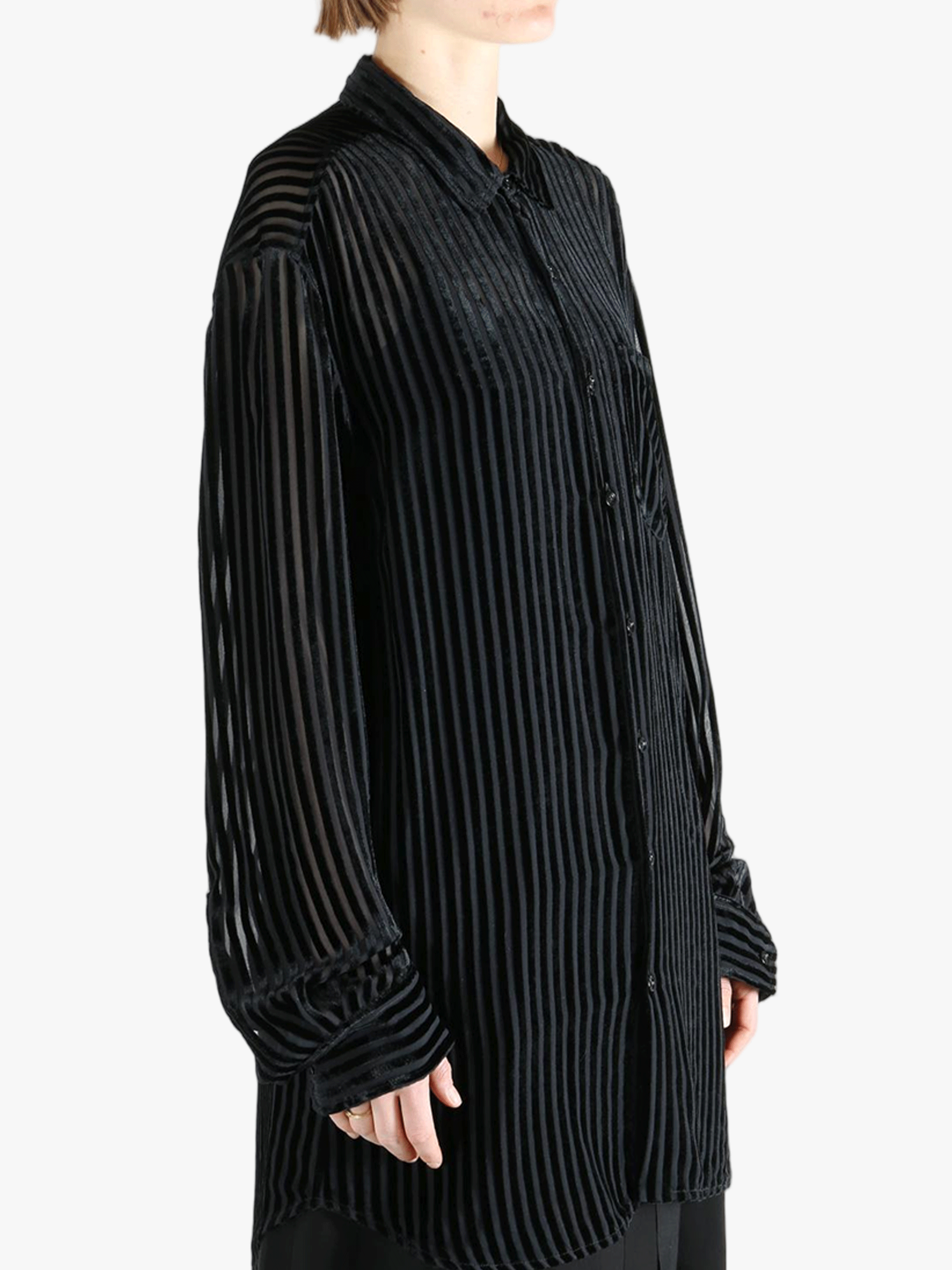 Black shirt worn by a person, showing the shirt's fit