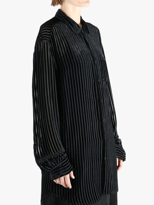 Black shirt worn by a person, showing the shirt's fit