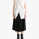 White top worn by a person, showing the top's fit