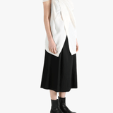 White top worn by a person, showing the top's fit