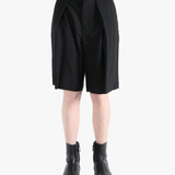 Black short worn by a person, showing the short's fit