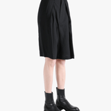 Black short worn by a person, showing the short's fit