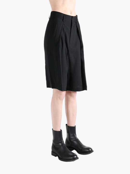 Black short worn by a person, showing the short's fit