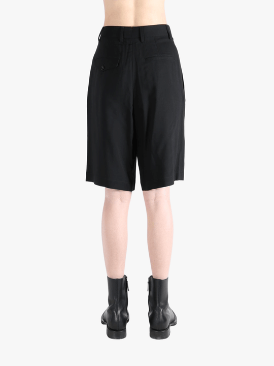 Black short worn by a person, showing the short's fit