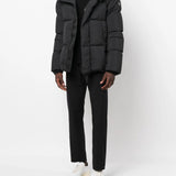 Black coat  worn by a person, showing the coat's fit