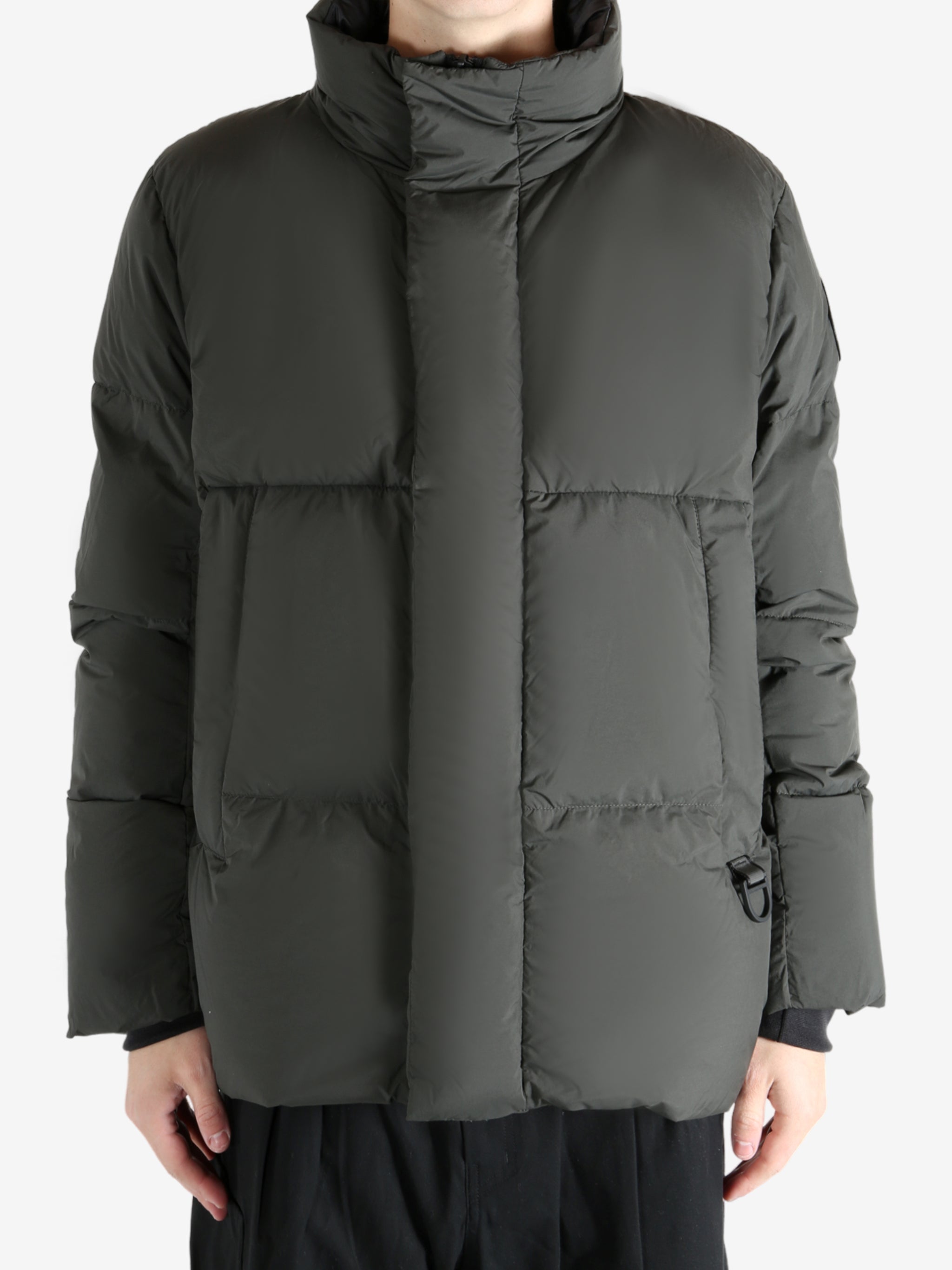 Green jacket worn by a person, showing the coat's fit